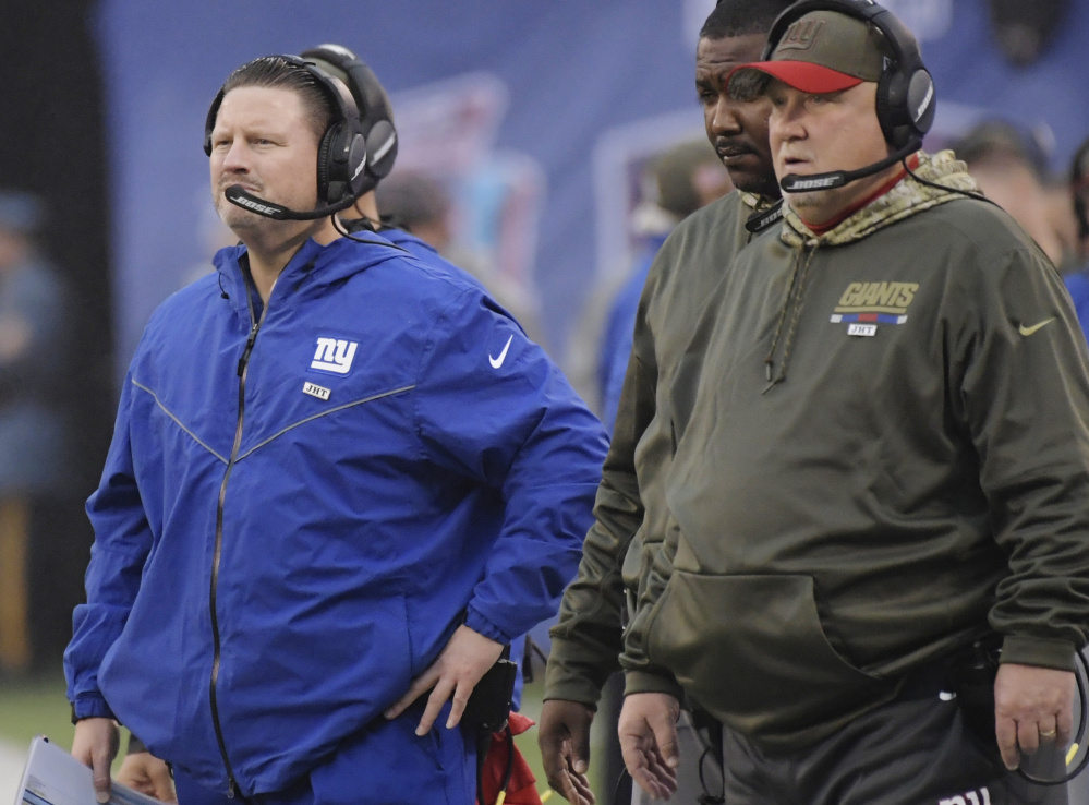 Ben McAdoo, left, is under fire with the Giants losing 7 of 8 games this year, including a Sunday 51-17 blowout at home to the Los Angeles Rams.
Associated Press/ Bill Kostroun