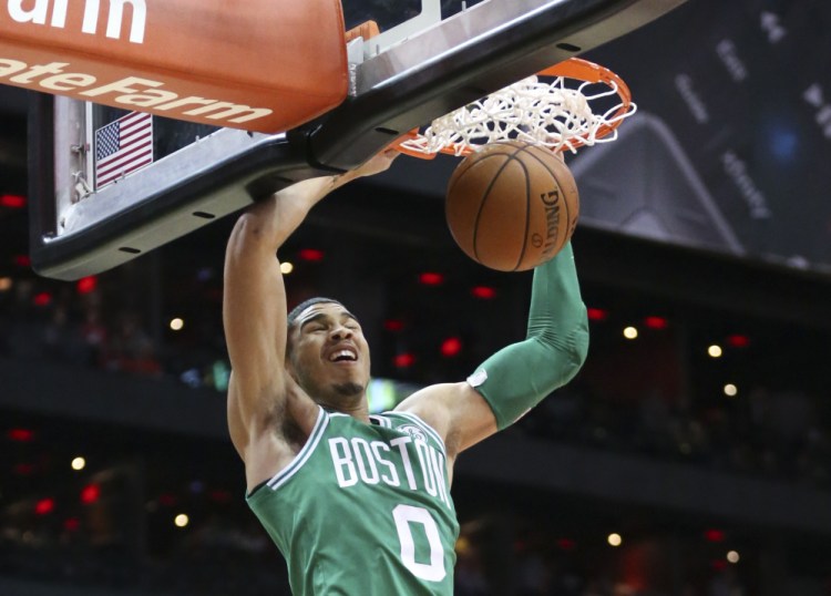 Celtics forward Jayson Tatum scores in the first half of Monday night's game in Atlanta, Boston's ninth straight win. Tatum finished with 21 points.