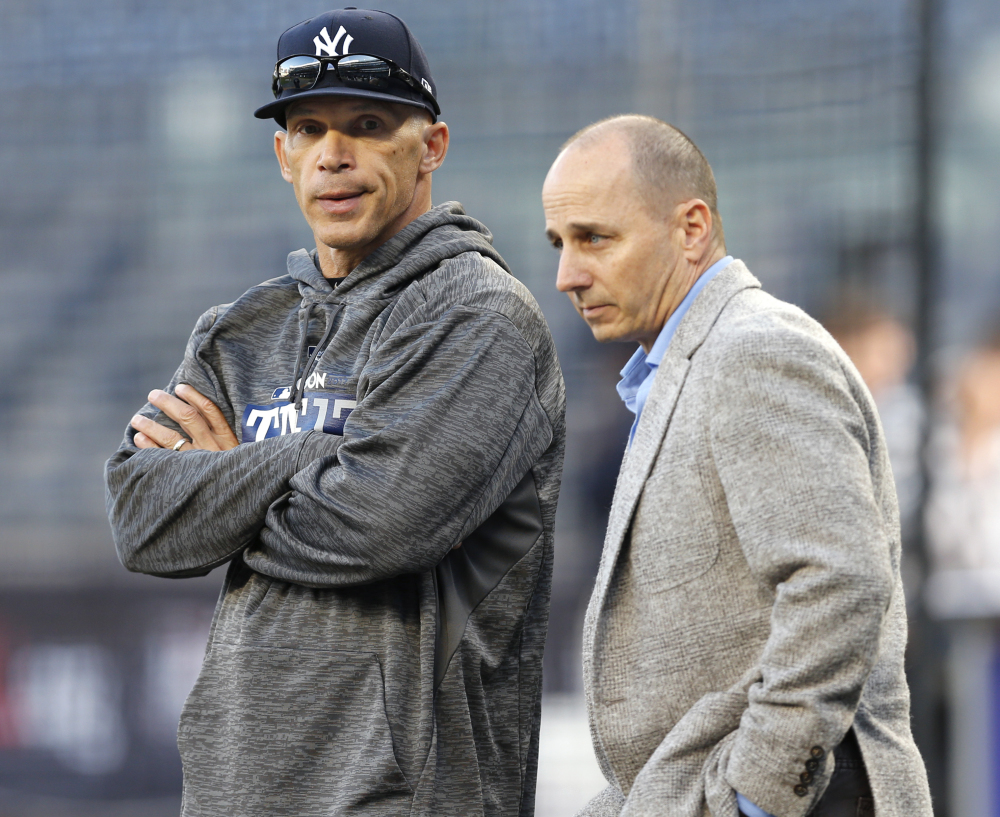 Yankees General Manager Brian Cashman, right, said former manager Joe Girardi, left, may have faced hurdles communicating with his players after 10 years on the job.