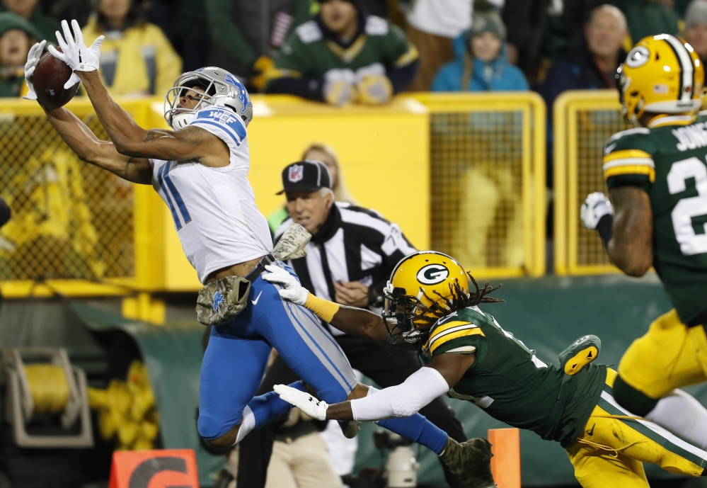 Detroit's Marvin Jones catches a touchdown pass in front of Green Bay's Davon House during the first half Monday night in Green Bay, Wisc. The Lions won, 30-17.