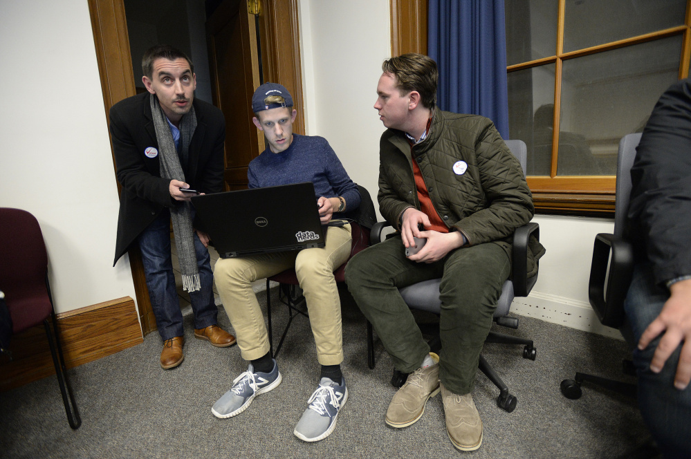 City Council District 4 candidate Justin Costa watches election results come in Tuesday at Portland's City Hall with Simon Thompson and Eamonn Dundon, who both worked with Jill Duson's campaign. (Staff photo by Shawn Patrick Ouellette/Staff Photographer)