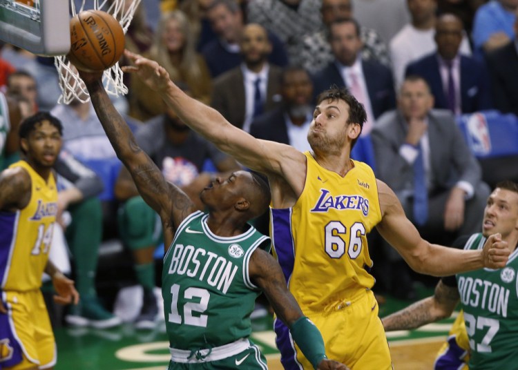 Boston's Terry Rozier goes to the basket past Los Angeles' Andrew Bogut in the first quarter on Wednesday night in Boston.
