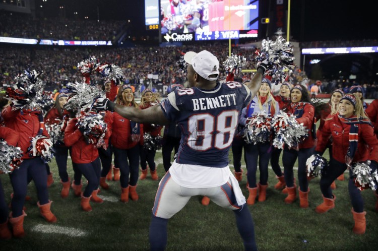 Tight end Martellus Bennett celebrates with cheerleaders after the Patriots won the AFC championship on Jan. 22, 2017, in Foxborough, Mass. The Patriots defeated the the Steelers 36-17 to advance to the Super Bowl. Bennett left for Green Bay in the offseason, but came back to the Patriots on Thursday.