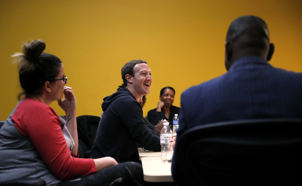 Facebook CEO Mark Zuckerberg, center, meets entrepreneurs and innovators at Cortex Innovation Community hub Thursday in St. Louis. Zuckerberg announced a program to boost small businesses and bolster digital skills.