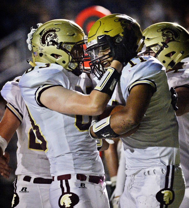 CJ LaBreck, right, is congratulated by a teammate after one of his two touchdown receptions during Thornton Academy's 32-28 win over Scarborough on Sept. 15. The teams clash again Friday night in Scarborough, with a trip to the Class A state championship game on the line.