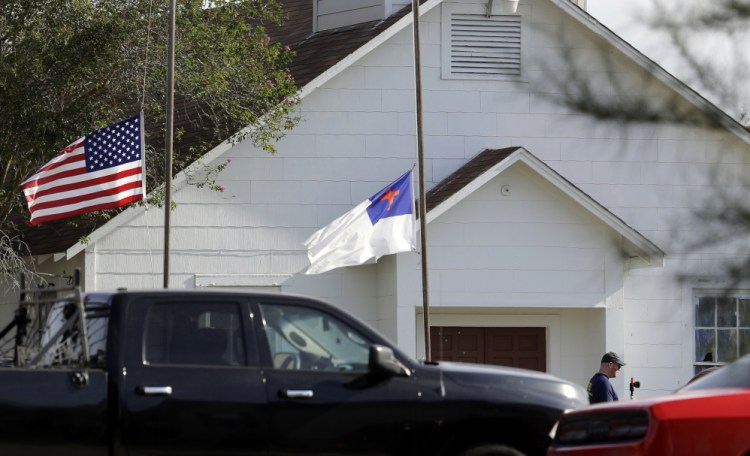 Flags fly at half-staff on Nov. 7 after a shooting at the First Baptist Church of Sutherland Springs in Sutherland Springs, Texas. A story claiming a man who killed more than two dozen people at the church on Sunday was a member of an anti-fascist movement intent on causing a civil war was false, the Associated Press reports.