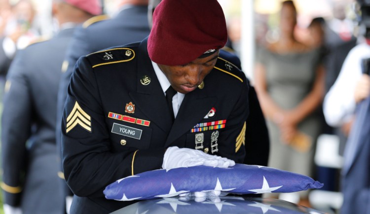 An honor guard member touches an American flag to the coffin of Sgt. La David Johnson, one of four soldiers killed in Niger, at a service on Oct. 21. The deaths should raise awareness that we're still engaged in the war on terrorism.