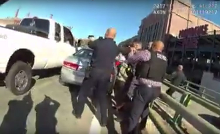 A still image from a Providence Police officer's body camera shows officers converging on the truck Friday. They fired over 40 rounds, killing the driver and injuring a woman passenger.