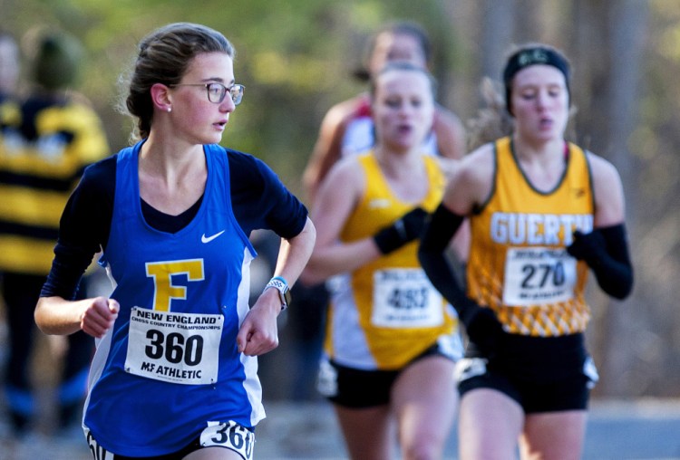 Sofie Matson of Falmouth looks over her shoulder during the New England high school cross country championships Saturday in Belfast. Matson was the first Maine girls' finisher, in 10th place.
