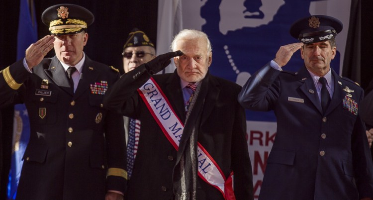 Former astronaut Buzz Aldrin, center, salutes during the annual Veterans Day parade in New York on Saturday. Aldrin served as grand marshal as he joined Mayor Bill de Blasio.