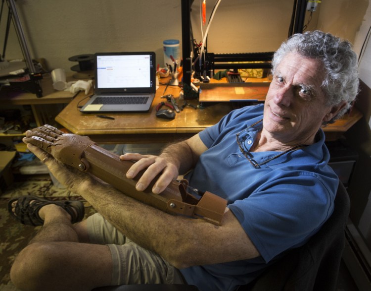 Dean Rock volunteers his time and money to make prosthetic forearms using a 3D printer in the basement of his Cumberland Center home. Most of his work has ended up in the Dominican Republic.