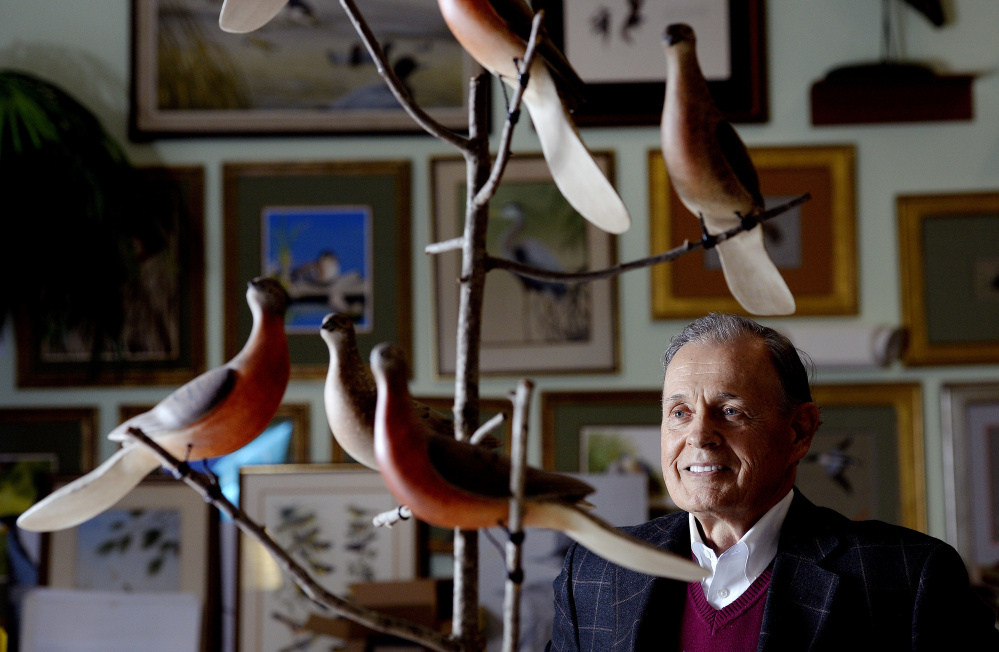 Eddie Woodin of Scarborough, honored by Historic New England for his bird art collection, admires "Passenger Pigeon," a piece by Maine artist Ken Kirby.