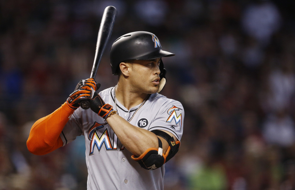 Signed to a pricy long-term contract with an opt-out clause,  Giancarlo Stanton would have to waive his no-trade status before the Red Sox or another team could acquire him.
