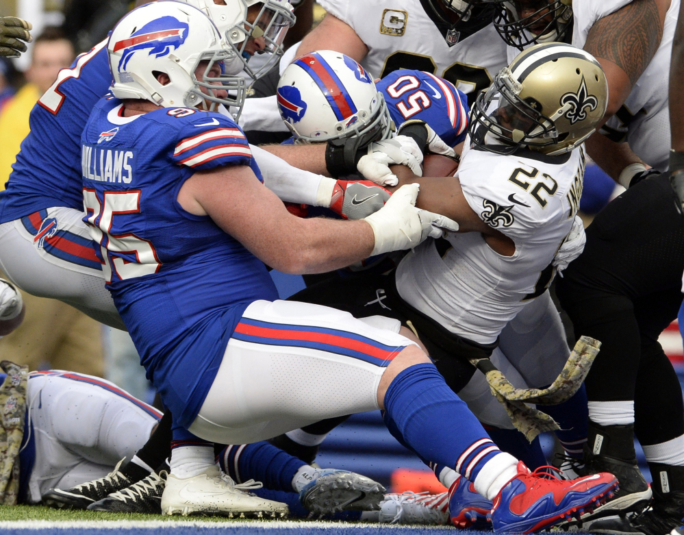 Mark Ingram of the Saints bulls his way into the end zone for one of his three touchdowns – and one of his team's six rushing TDs – in a 47-10 win Sunday over Buffalo.