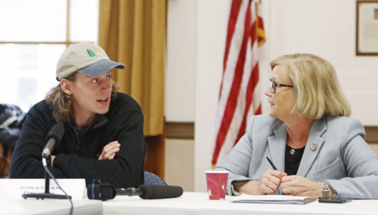 Jonathan Brown, a 2016 graduate of the University of New England, talks with U.S. Rep. Chellie Pingree during a round-table discussion at Portland City Hall regarding the Republican tax plan.