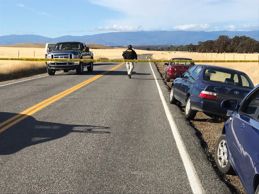 Crime tape blocks off Rancho Tehama Road leading into the Rancho Tehama subdivision south of Red Bluff, Calif., following  fatal shootings on Tuesday.