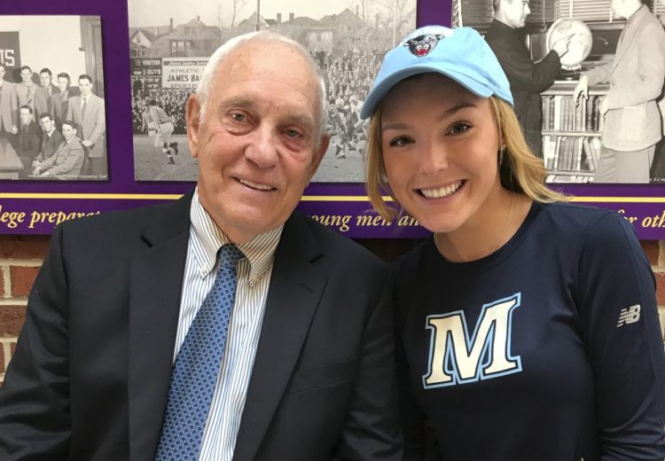 Hannah Abbott, a Cheverus senior, sits with her grandfather, former UMaine football coach Walt Abbott, after signing her letter of intent.