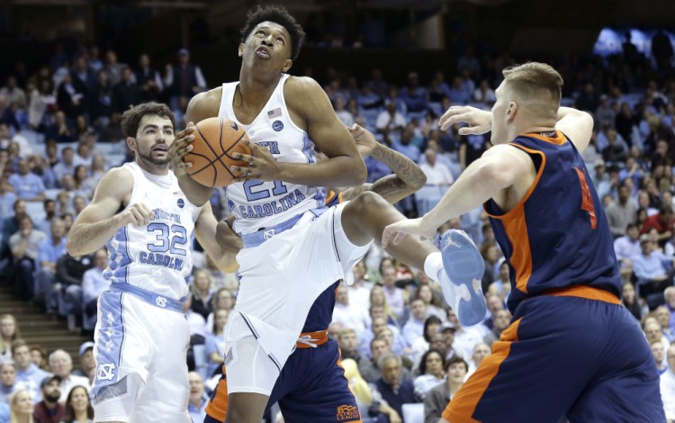 Sterling Manley of North Carolina collects a rebound in front of teammate Luke Maye as Nate Sestina of Bucknell moves in Wednesday night during the first half of North Carolina's 93-81 victory.