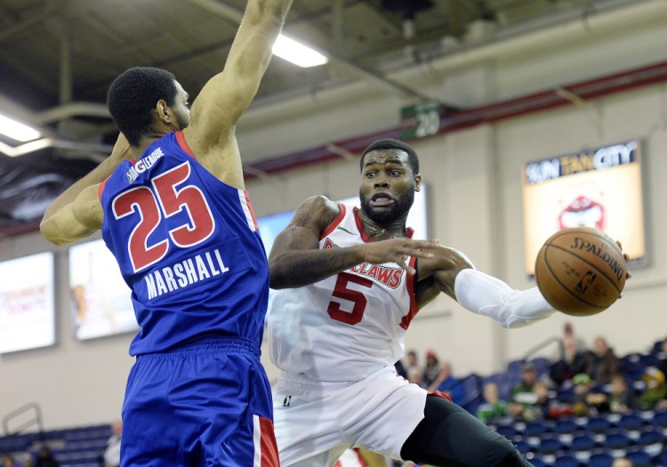 Kadeem Allen of the Red Claws passes the ball against Zeke Marshall of the Grand Rapids Drive during Maine's 99-96 win Thursday night at the Expo.
