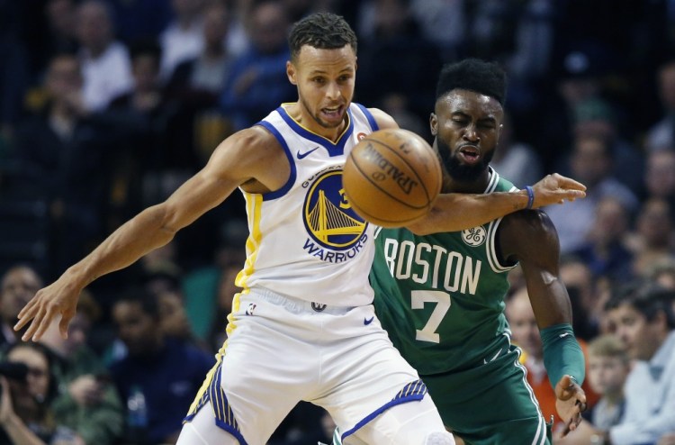 Boston's Jaylen Brown and Golden State's Stephen Curry battle for a loose ball during the first quarter of Thursday night's game in Boston. The Celtics won 92-88.
