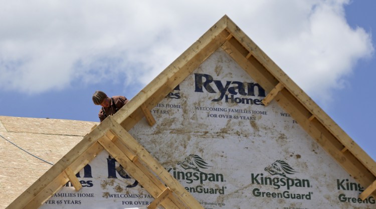 A builder works on the roof of a home under construction at a housing development in Jackson Township, Butler County, Pa. Apartment complexes drove new construction in the Northeast.