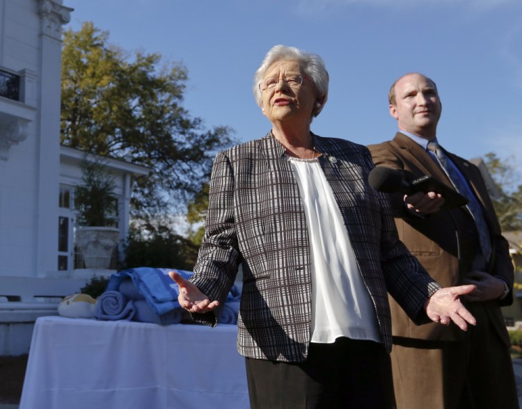 Alabama Gov. Kay Ivey speaks to the media Friday in Montgomery. Ivey said she plans to vote for Roy Moore.