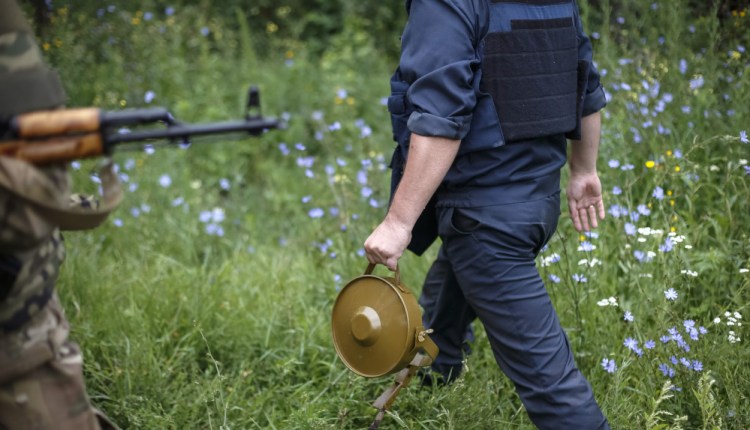 A military demolitions expert, or sapper, holds a land mine  in the eastern Ukrainian village of Semenovka in 2014.