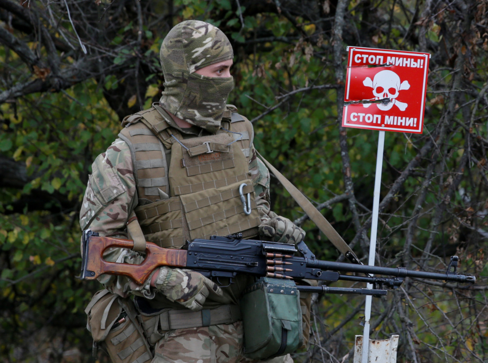 A mine warning is displayed at a checkpoint on the contact line between pro-Moscow rebels and Ukrainian troops.