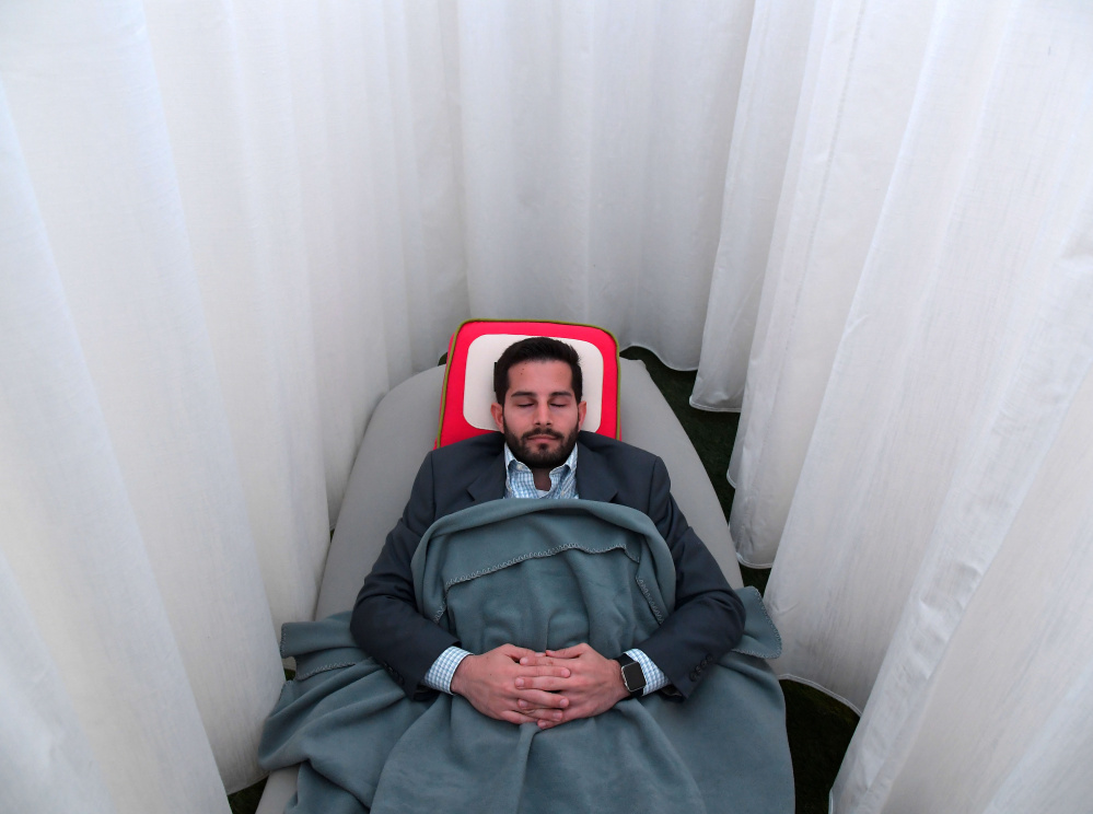 An on-the-job napping cocoon at Recharj in Washington, D.C., may leave Daniel Turissini in a fine frame of mind to tackle his afternoon duties.