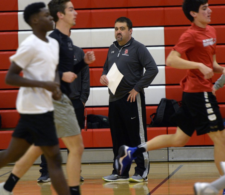 South Portland Coach Kevin Millington watches his boys' basketball players run Monday on the first day of practice for Maine's winter sports teams. South Portland was the Class AA runner-up the last two seasons.