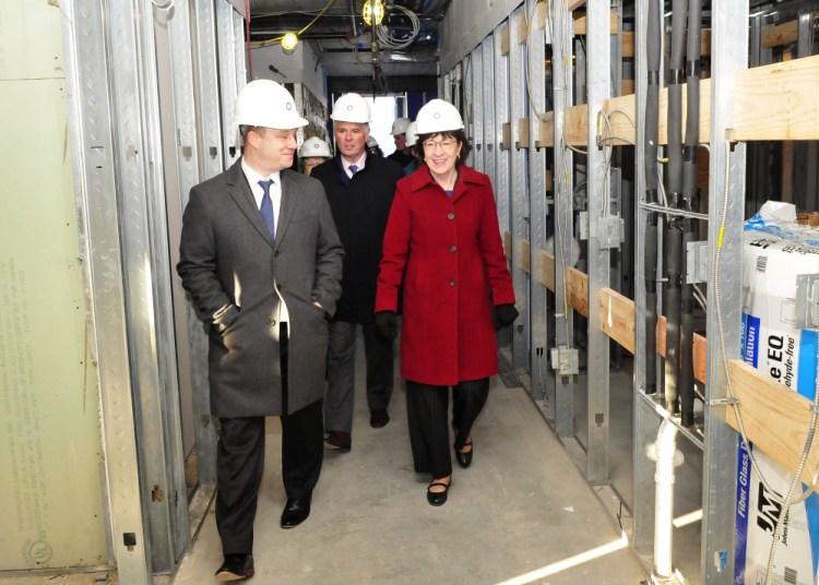 U.S. Sen. Susan Collins, R-Maine, Colby College President David Greene, center, and Brian Clark, Colby's vice president of planning, tour Colby's unfinished multi-purpose residential building Monday in downtown Waterville.