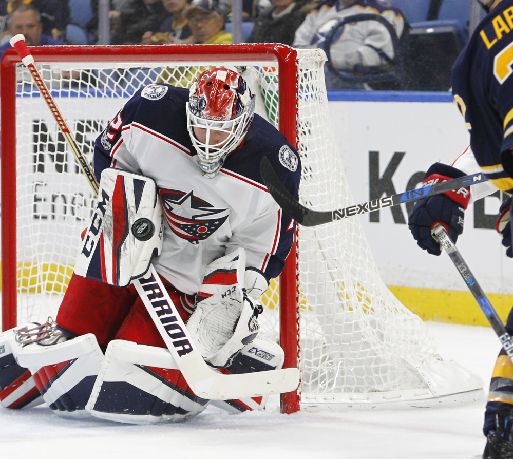 Columbus goaltender Sergei Bobrovsky wards off a shot with his blocker during the first period of the Blue Jackets' 3-2 win over the Sabres on Monday in Buffalo.