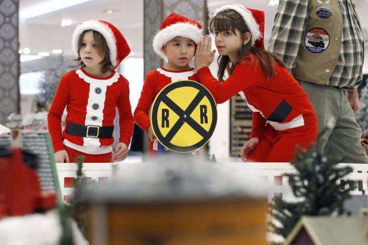 Jackson Garcia, 6, center, is flanked by his cousins Emma Bennett, 6, left, and her sister Elizabeth Bennett on Wednesday as they survey a sprawling series of model train sets at the Winter Wonderland at the Maine Mall. Retailers are gearing for the heavily hyped Black Friday this week, but it isn't actually the busiest shopping day of the holiday season.