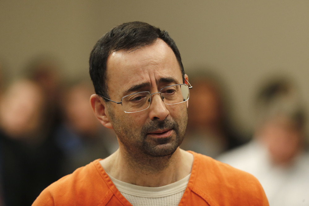 Larry Nassar appears in court for his plea hearing Wednesday in Lansing, Mich. Nasser, a former sports doctor accused of molesting girls while working for USA Gymnastics and Michigan State University, pleaded guilty to multiple charges of sexual assault and faces at least 25 years in prison.