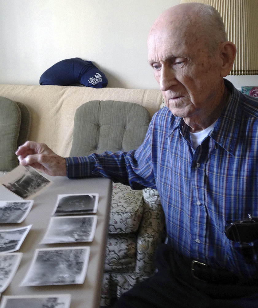 Kenneth F. Lincoln, 90, with photos taken when he was in the U.S. Navy and fighting a large fire in Rabat, Morocco, in 1946.