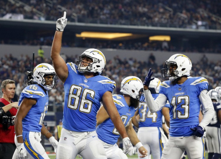 Hunter Henry, center, of the Chargers celebrates his touchdown catch with Tyrell Williams. left, and Keenan Allen (13) in the second half Thursday's game against the Cowboys in Arlington, Texas. TheChargers rolled to a 28-6 win.