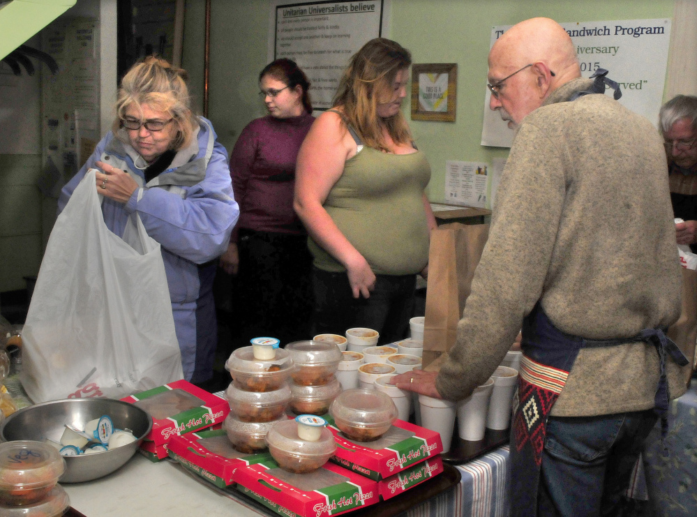 Volunteer Bruce O'Donnell serves at the Evening Sandwich program at the Unitarian Universalist Church in Waterville on Tuesday. It is among the organizations benefiting from the new Food Recovery Program.