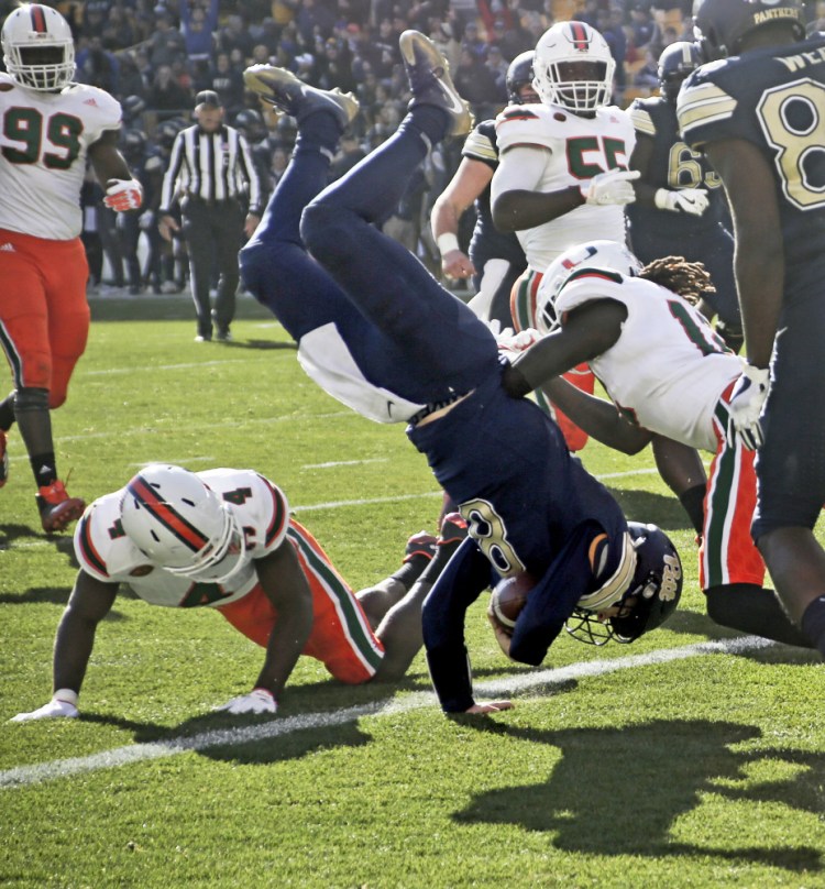 Pitt quarterback Kenny Pickett flips over defensive back Jaquan Johnson during the first half of the Panthers' 24-14 win over Miami in Pittsburgh on Friday. (AP Photo/Keith Srakocic)