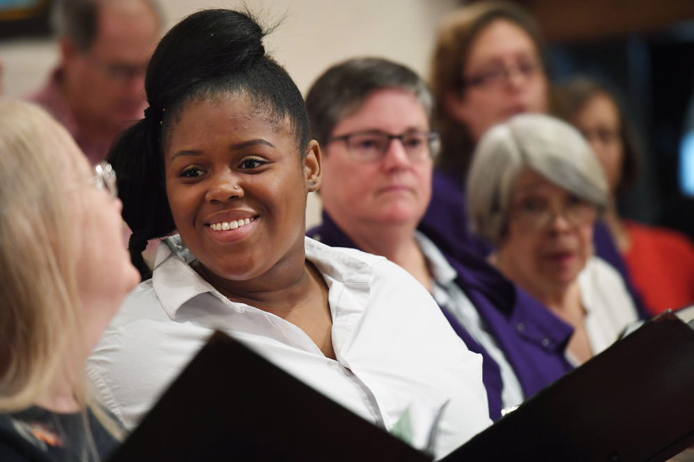 Pamela Perry, left, and Patrice Eubanks talk during a St. Margaret's choir rehearsal. The church has seen attendance rise this year.