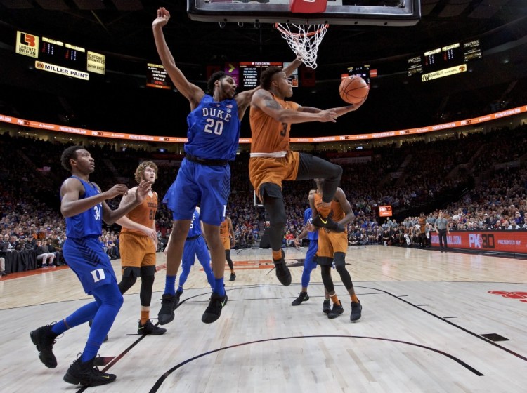 Texas guard Jacob Young goes up for a shot with Duke center Marques Bolden defending during their semifinal in the PK80 Invitational tournament in Portland, Ore. Duke overcame a 16-point deficit to win 85-78 in overtime.