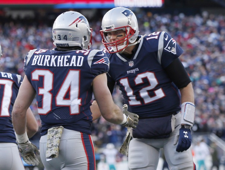 Tom Brady celebrates a touchdown pass to running back Rex Burkhead in the first half of the Patriots' 35-17 win over the Miami Dolphins on Sunday in Foxborough. New England is on track for yet another AFC East title.