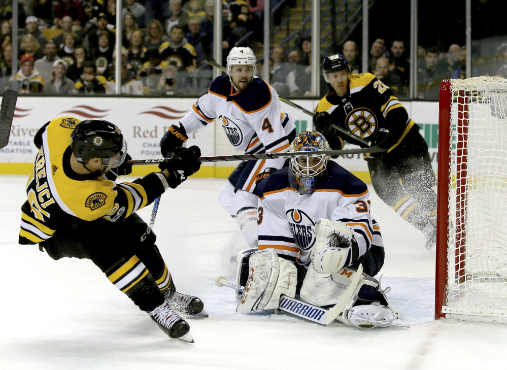 Boston Bruins center David Krejci scores against Edmonton Oilers goaltender Cam Talbot, tying Sunday's game in Boston at 2-2 with 4:29 left in the second period. The Oilers scored twice in the third period to win 4-2.