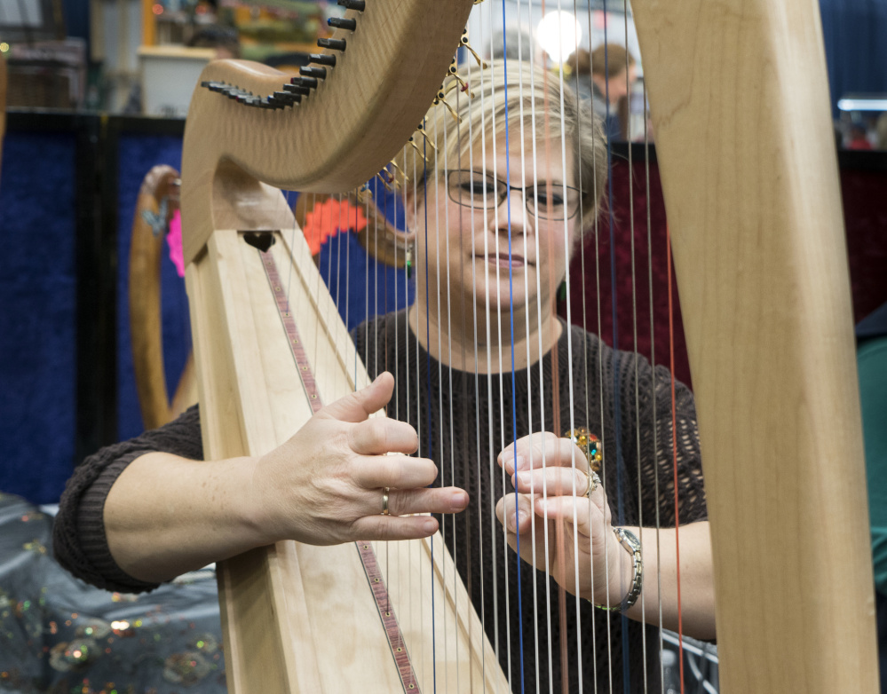 Mellori Worthen of Mercer plays the harp at the Maine Made Crafts Show at the Augusta Civic Center on Sunday. 
