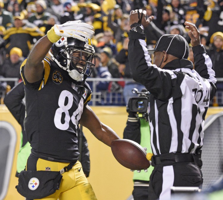 Pittsburgh wide receiver Antonio Brown celebrates his touchdown catch in front of field judge Dale Shaw during the second half against the Green Bay Packers in Pittsburgh on Sunday night. The Steelers won, 31-28.