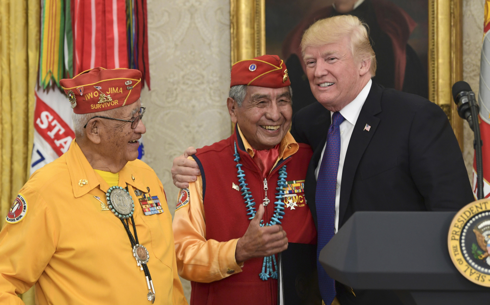 President Trump meets with former Navajo code talkers Peter MacDonald, center, and Thomas Begay, left, in the Oval Office of the White House in Washington on Monday.