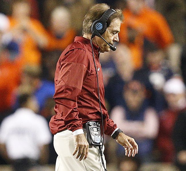 Alabama Coach Nick Saban walks off the field with his head down during Saturday's loss to Auburn.