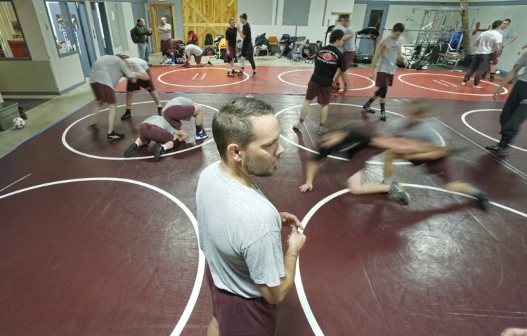 Kevin Gray watches wrestlers practice at the Knowlton School in Berwick on Monday. Gray has taken over as wrestling coach from Kip Devoll, who led Noble wrestling teams to 12 state titles.