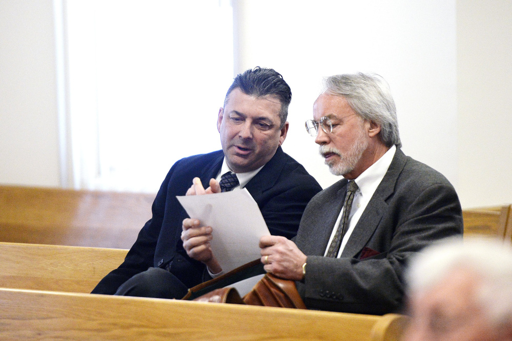 Former Ogunquit Town Manager Thomas Fortier, left, talks with attorney Bruce Merrill at a court proceeding in March. Fortier's theft trial ended Wednesday in a mistrial.