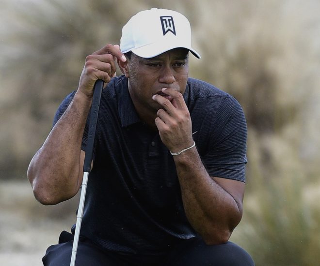 Tiger Woods prepares for a shot Thursday during the first round of the Hero World Challenge in Nassau, Bahamas. Woods, in his first competitive round since February, shot a 3-under 69.
