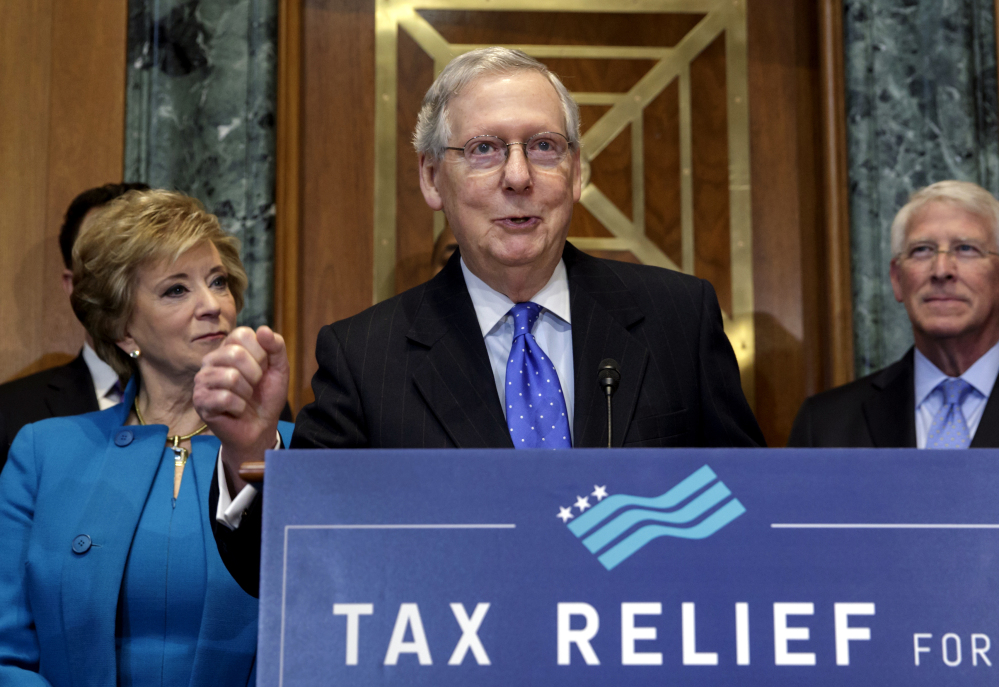 Senate Majority Leader Mitch McConnell, flanked by Small Business Administration chief Linda McMahon, left, and Sen. Roger Wicker, R-Miss., speaks to small-business owners Thursday on Capitol Hill as Republicans work to pass their sweeping tax bill.